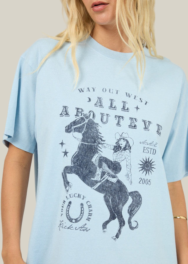 Light blue t-shirt with graphic design featuring a horse and text on a plain background