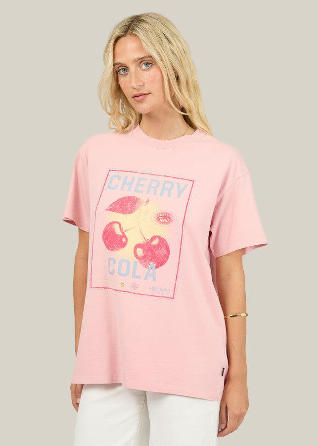 Person wearing a pink t-shirt with cherry cola graphic design on a plain background